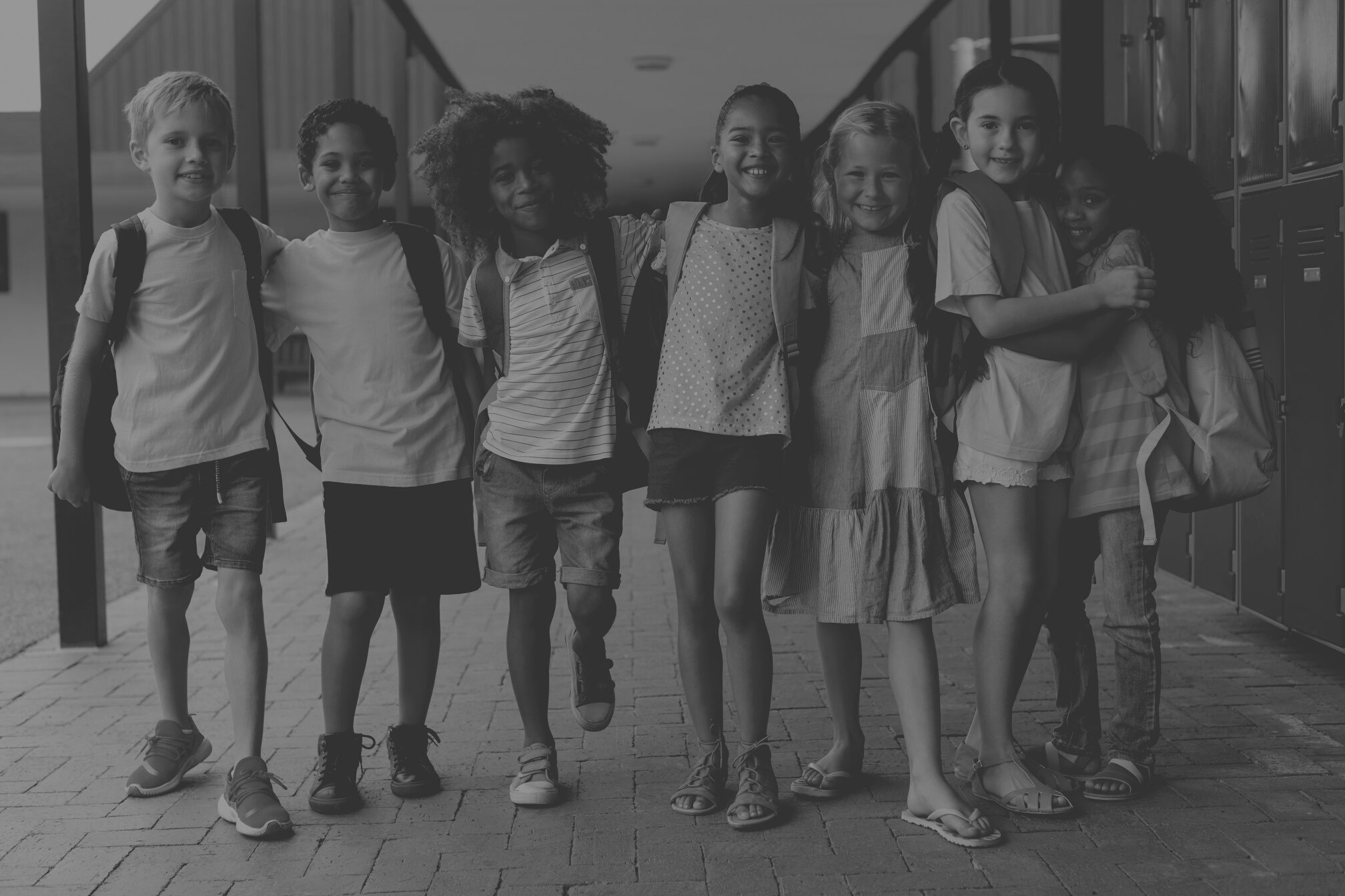 Happy school kids standing in corridor